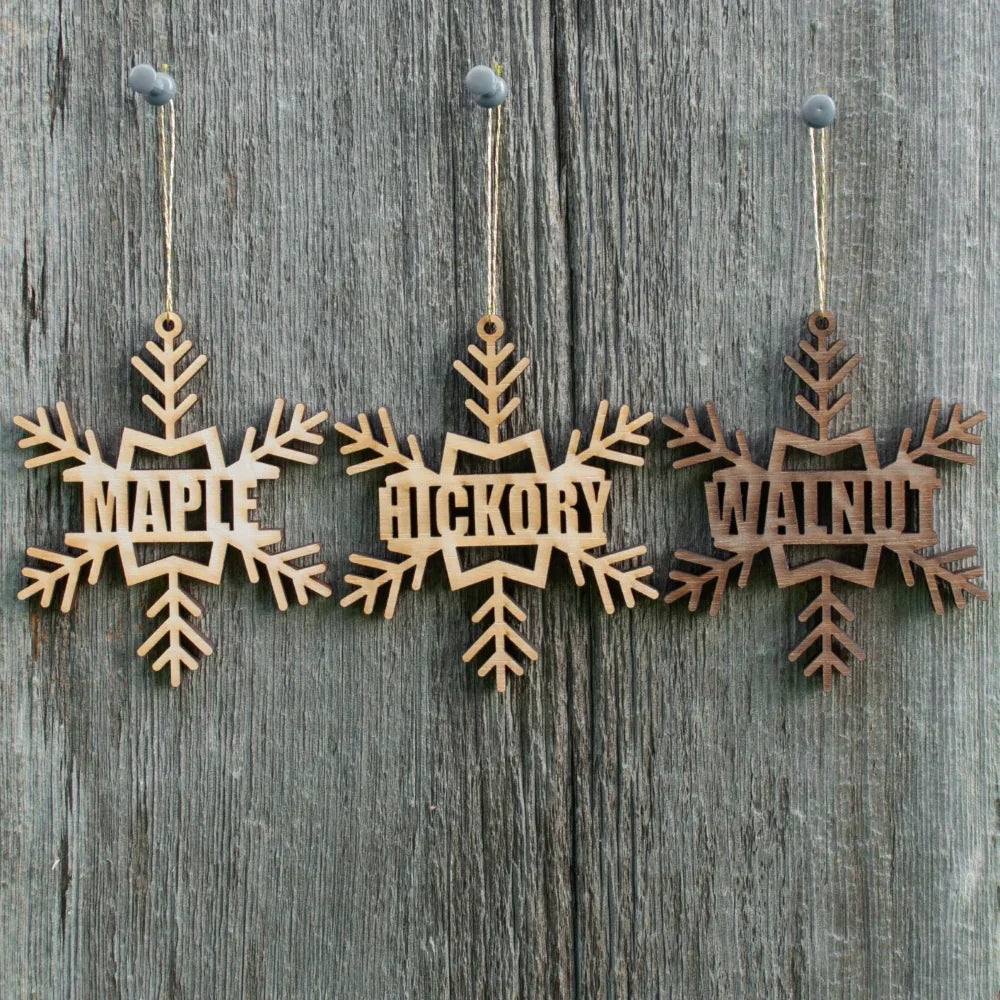 Set of hanging wooden name tags with snowflake and tree cutout shapes