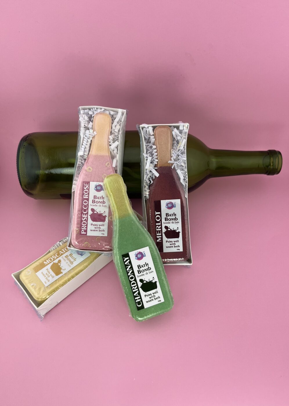 Assorted bottle-shaped bath bombs, green and tan with silver wrappers