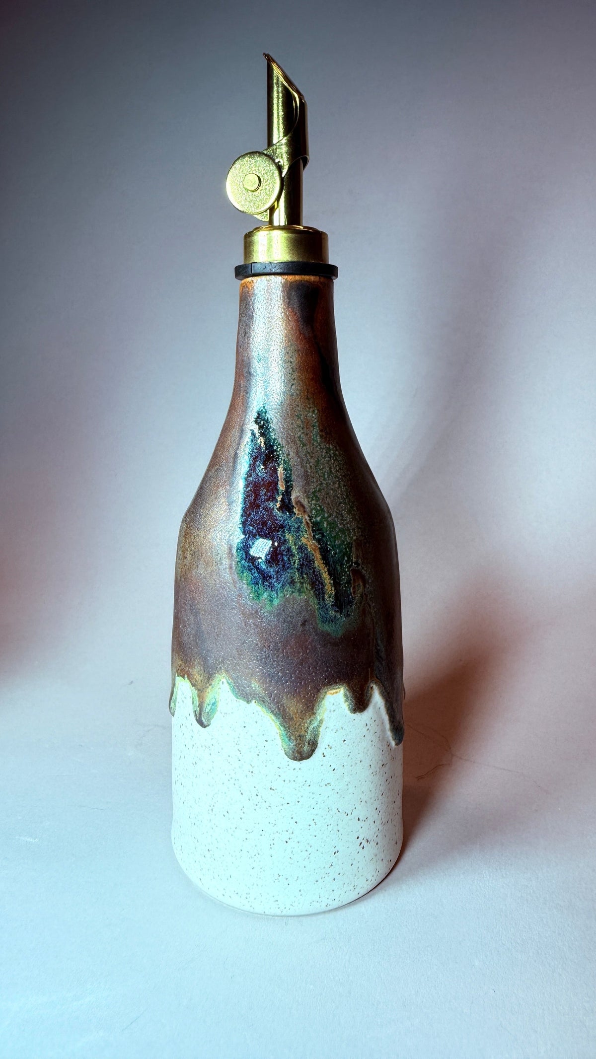 Ceramic-style decanter bottle with hinged pour spout and stopper, blue-green glaze drips