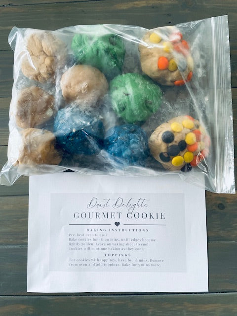 Frozen cookie dough assortment in clear bag with green, blue, and brown dough pieces