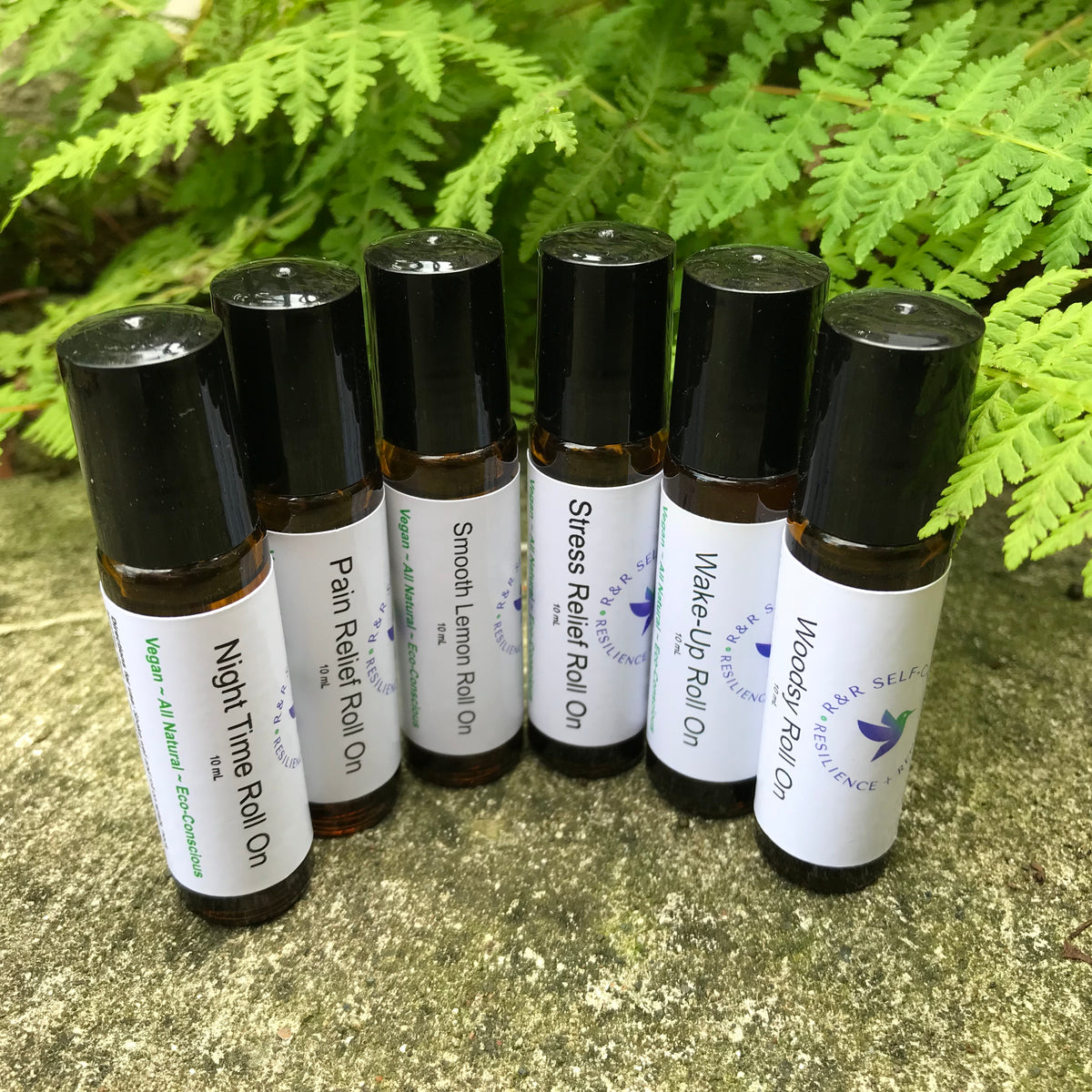 Essential oil roll-on bottles with black caps and white scent labels