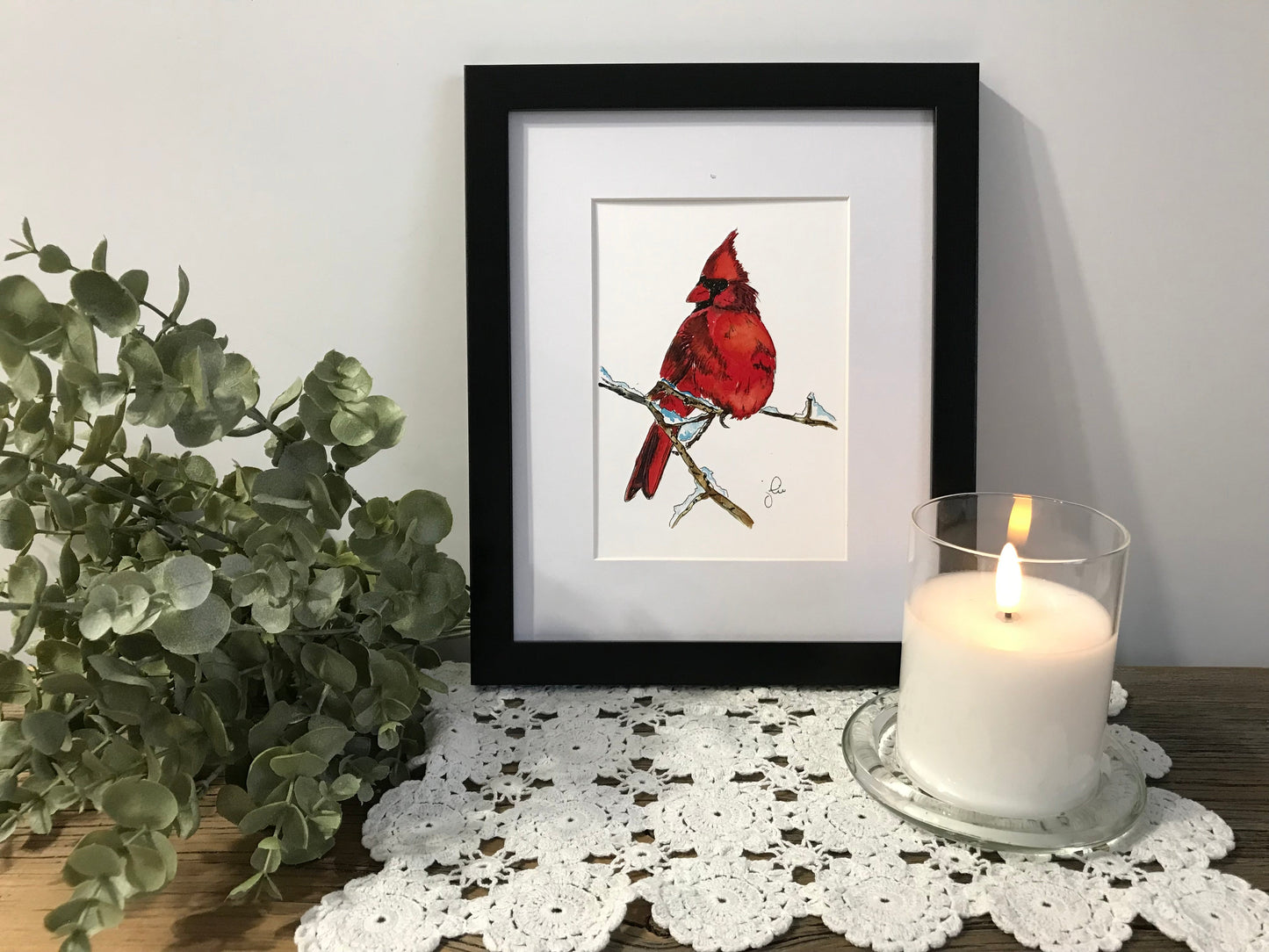 Single framed cardinal bird print with red cardinal on branch, black frame