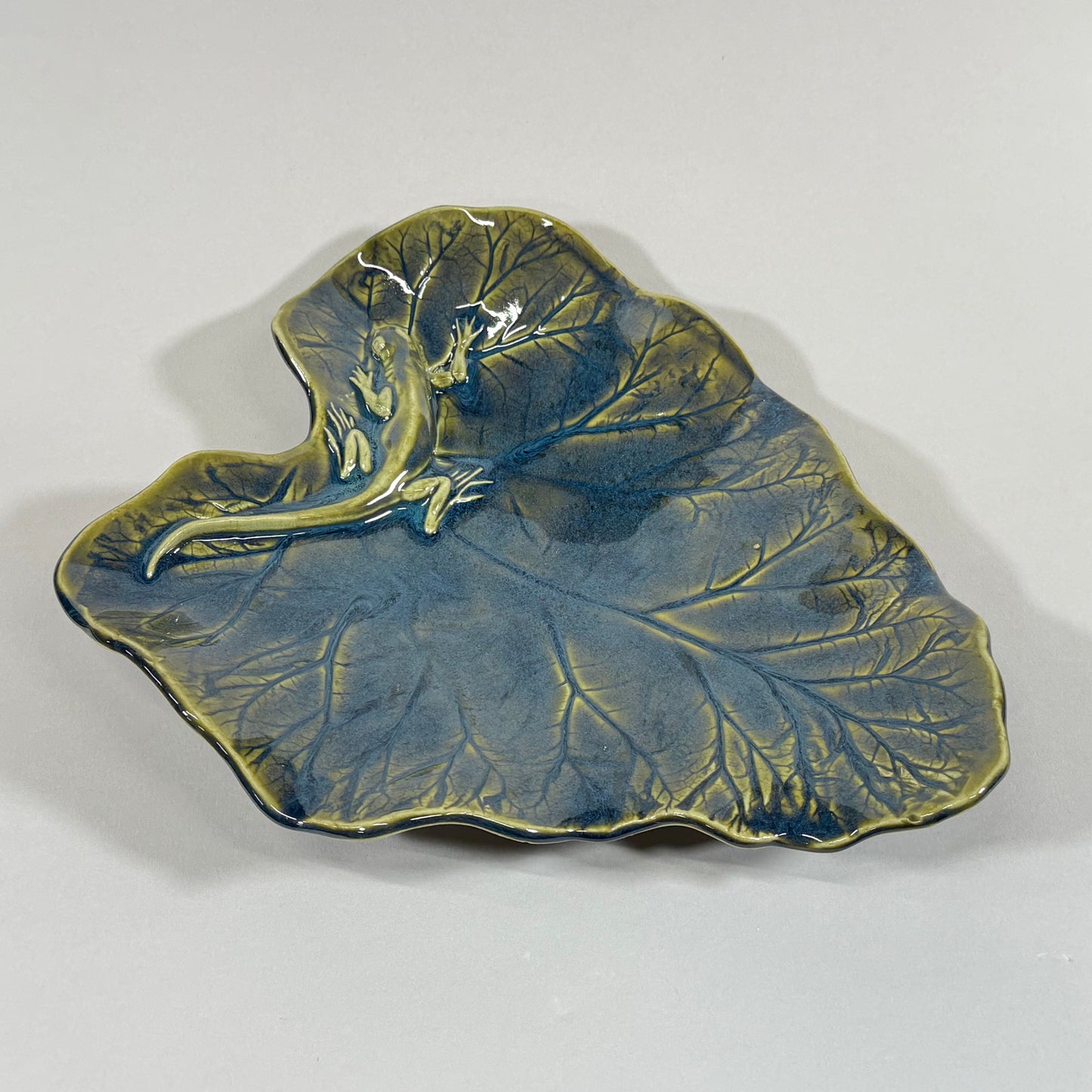 Rhubarb leaf-shaped serving platter, blue glaze with raised veins and gold rim