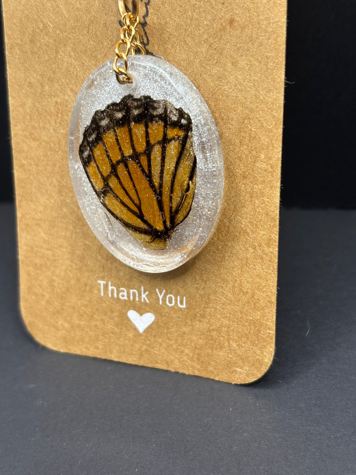 Butterfly wing keychain with oval resin pendant and metal chain link