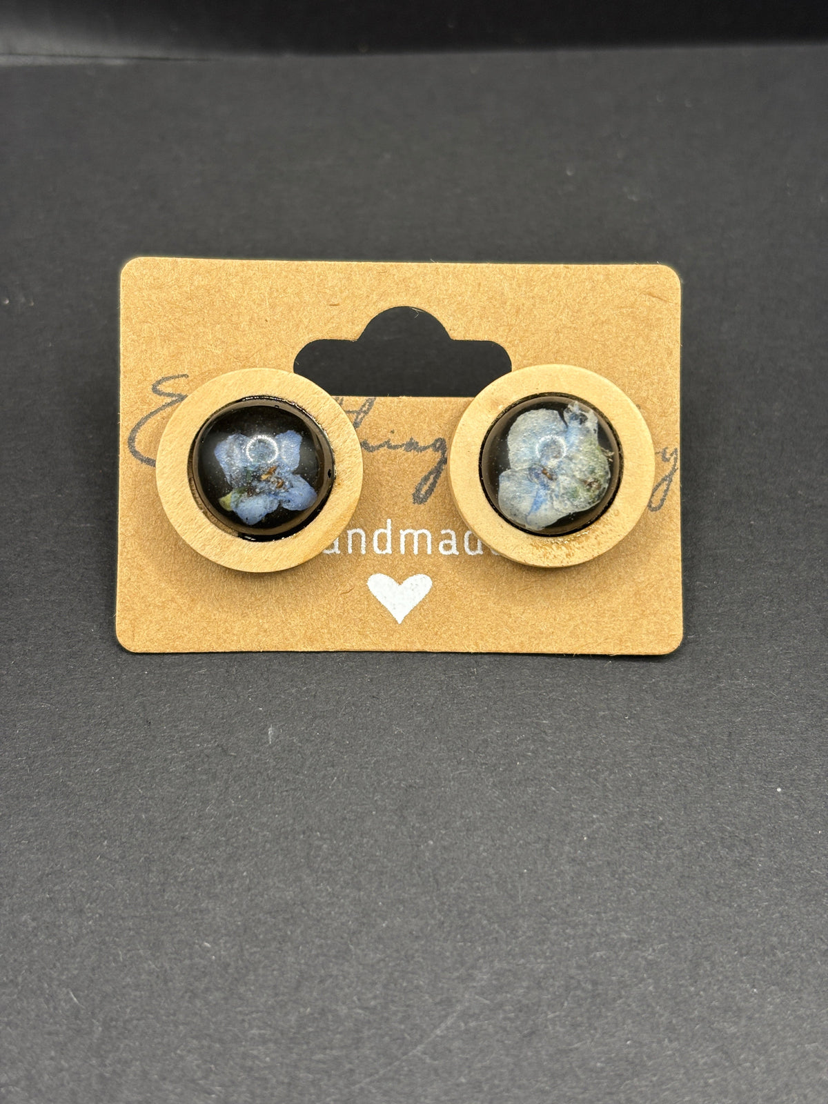 Round gold-tone forget-me-not style cabochon earrings with blue speckled domes