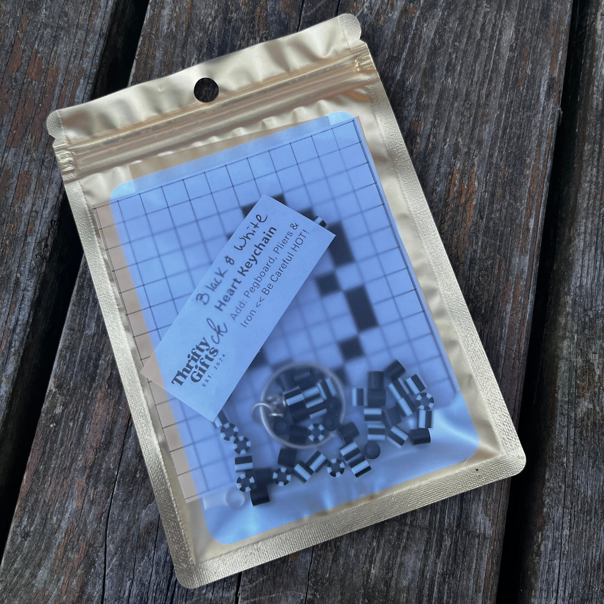 Heart bead keychain kit pouch with dark beads for a heart pattern on grid