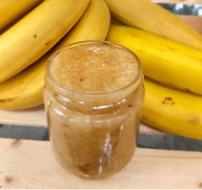 Banana jam in clear jar, golden-brown spread visible through lid