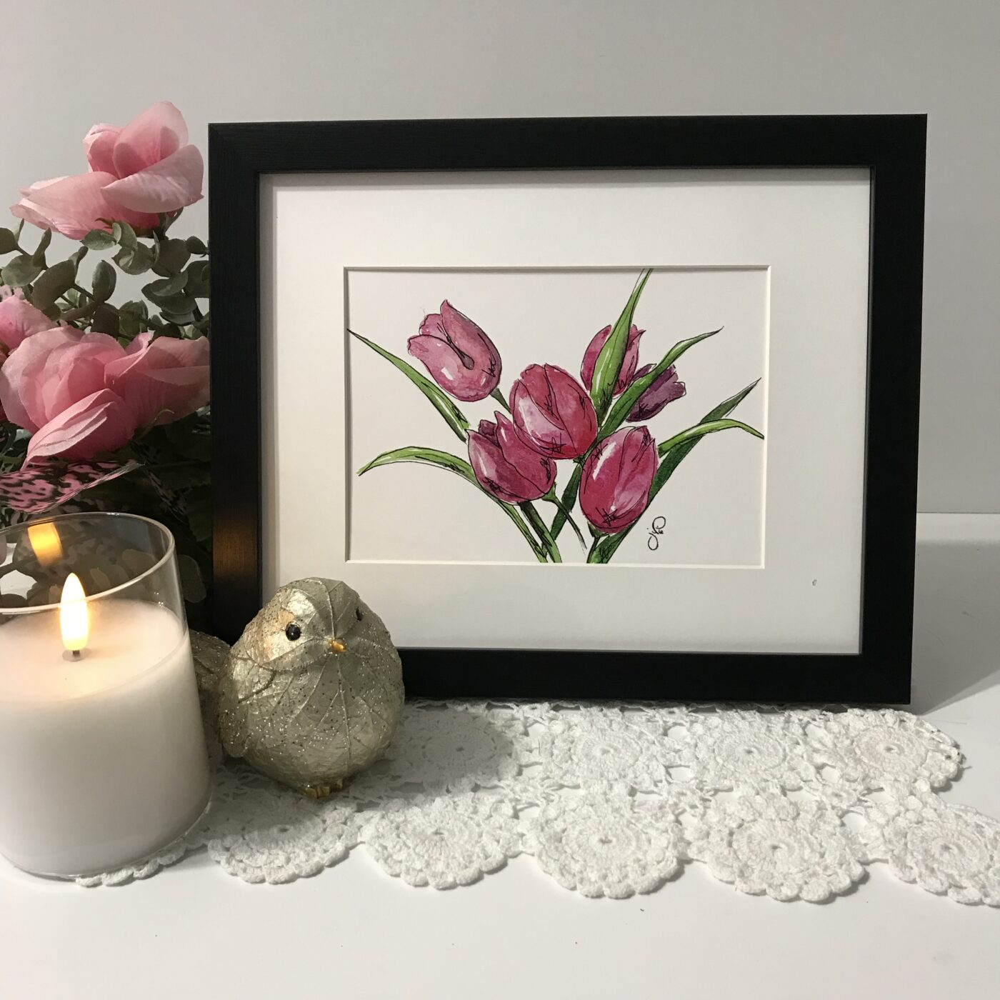 Framed wall art print featuring a bouquet of pink tulips with green stems