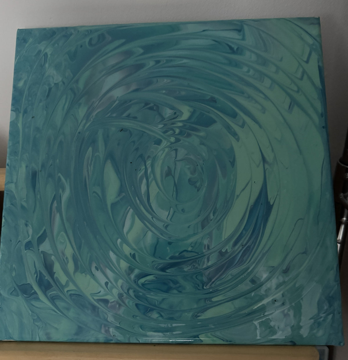 Teal abstract acrylic pour swirl canvas with concentric wave pattern