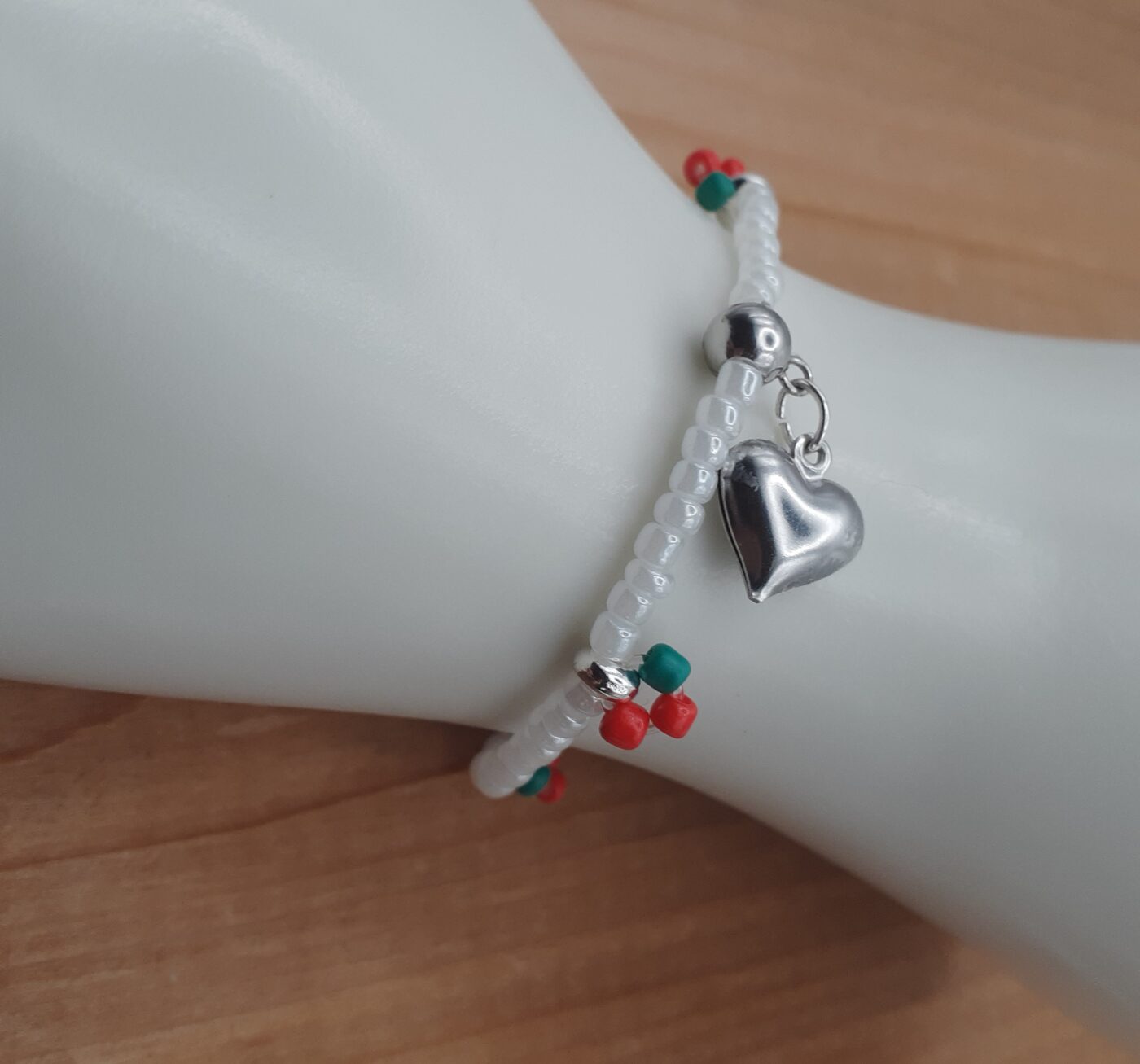 Cherry Love Stretch Bracelet White Seed Beads with Little Red and Green Fruity Accents of Colourful Beads and a Puffy Silver Heart Charm
