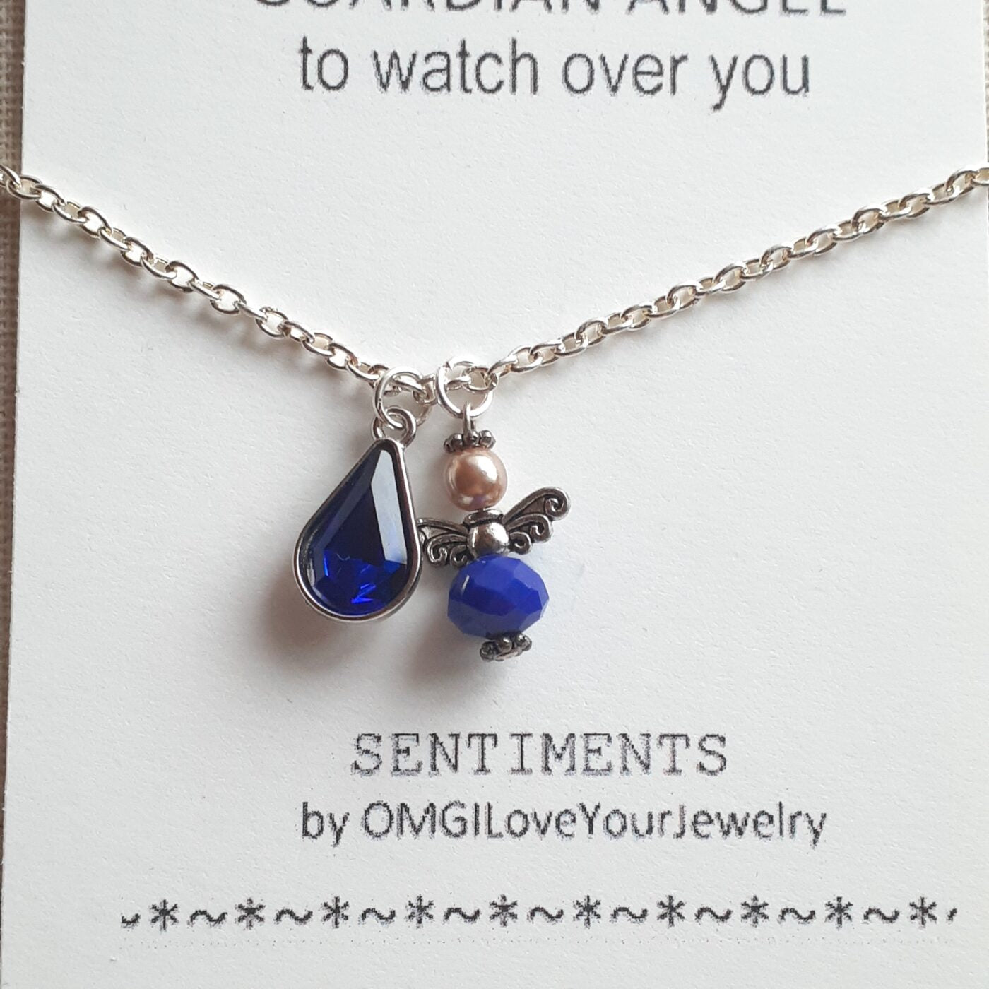 Faceted Opaque Sapphire Blue Czech Crystal and Pearl Guardian Angel Charm with a Blue Crystal Teardrop Charm on a Sterling Silver Thin Chain Necklace