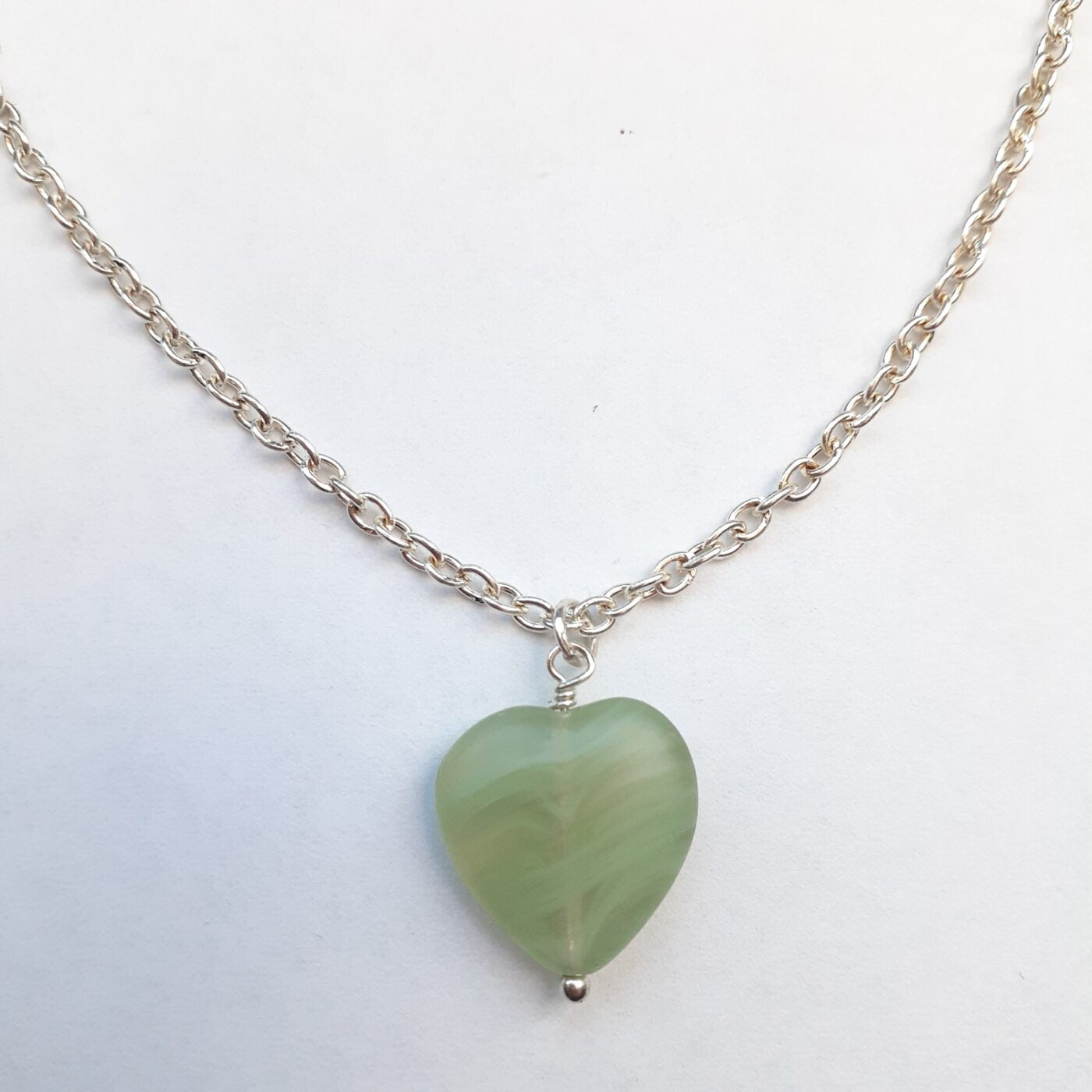 Green adventurine heart-shaped stone pendant on a sterling silver chain necklace