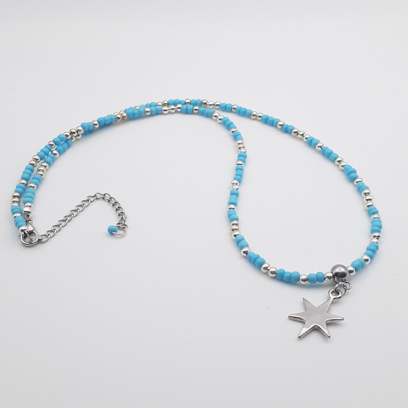 Shining Star Burst Silver Charm Blue Seed Bead Medium Length Necklace