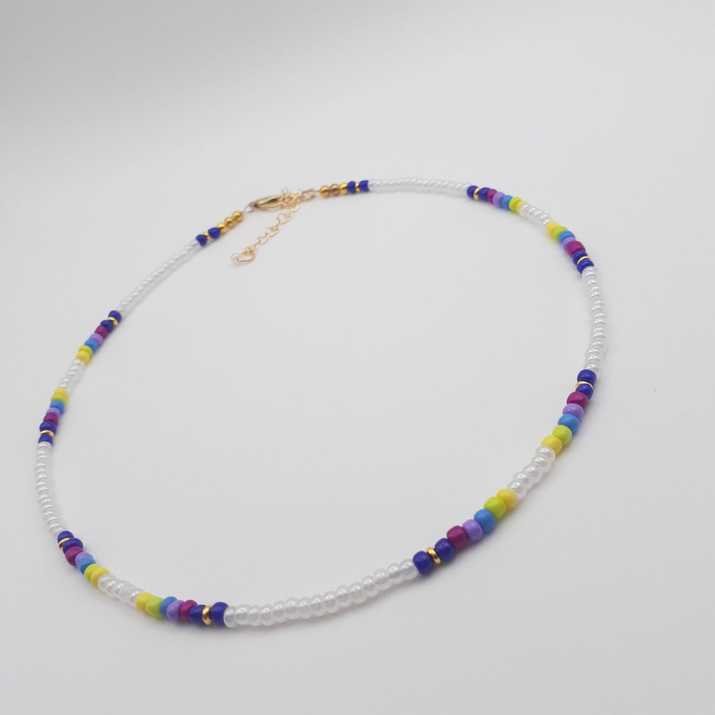 Short White Seed Bead Necklace with Splashes of Vibrant Colour Bands