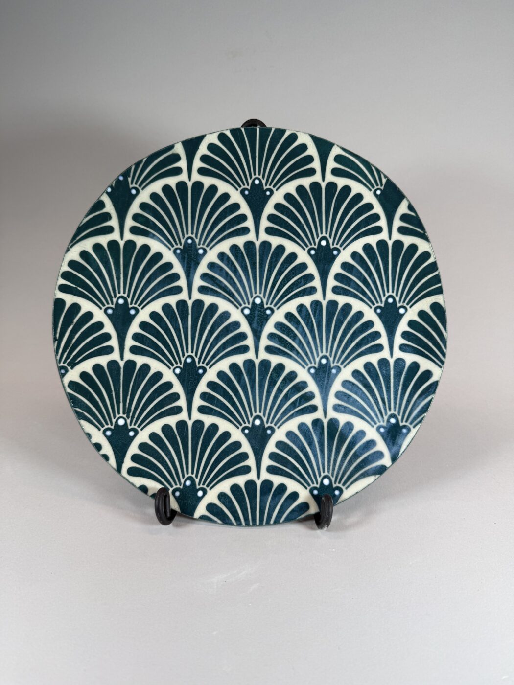 Decorative plate with art deco fan pattern in teal and cream