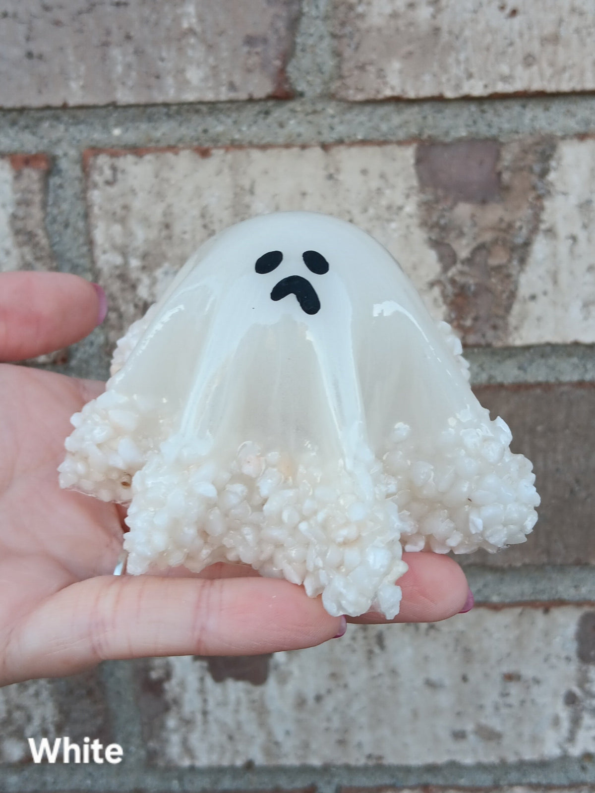Glow-in-the-dark ghost figurine, translucent white hood with white puff trim, medium