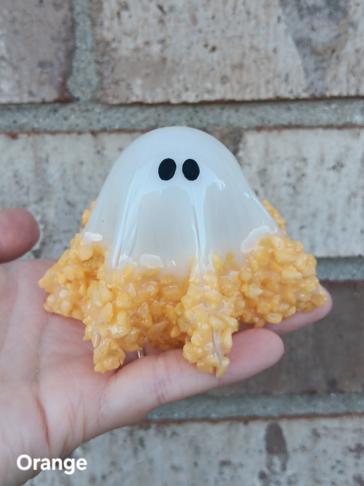 Glow-in-the-dark ghost figurine, white base with orange textured bottom, medium size