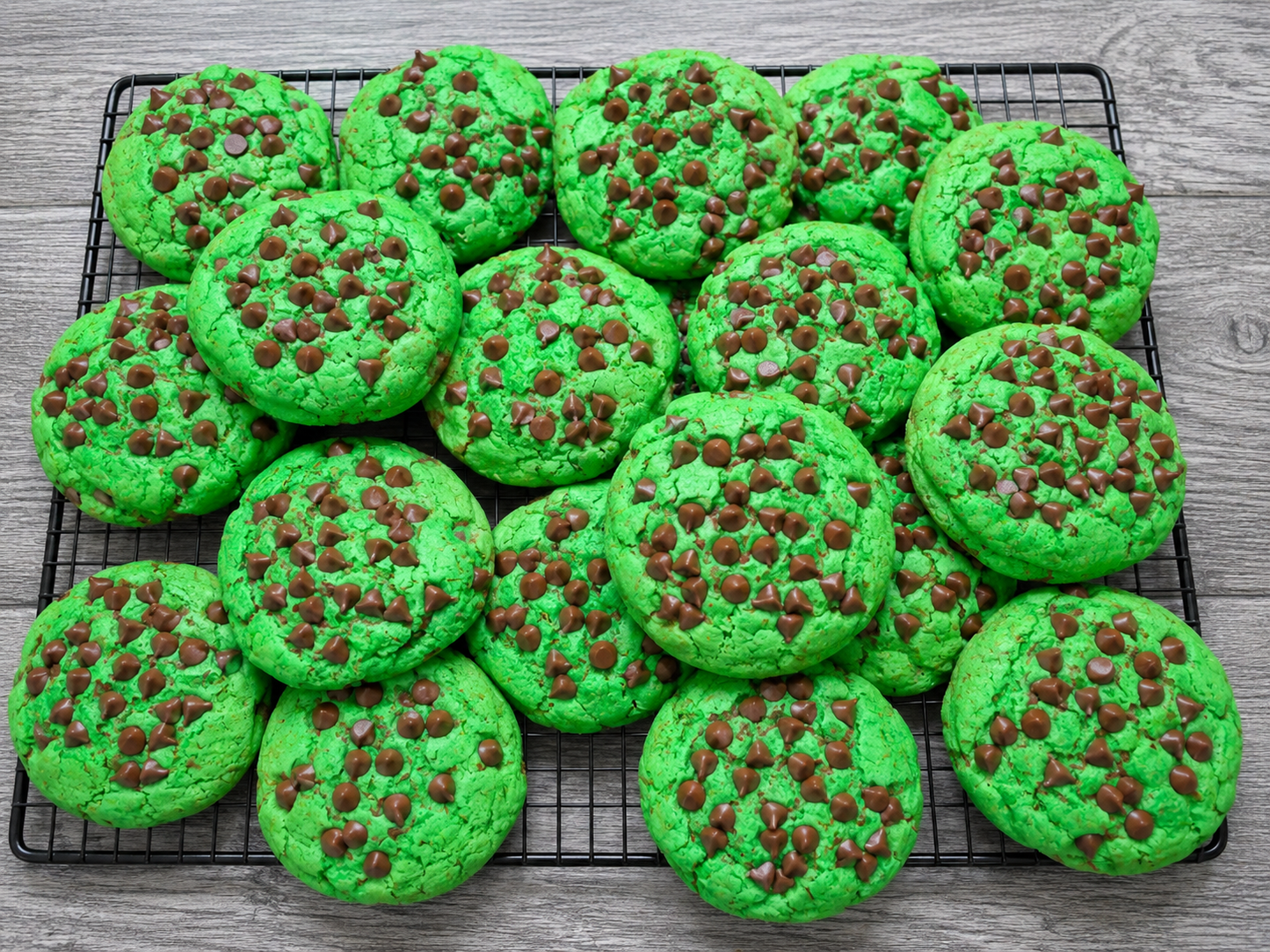 Green chocolate chip cookies with chocolate morsels, on a baking tray