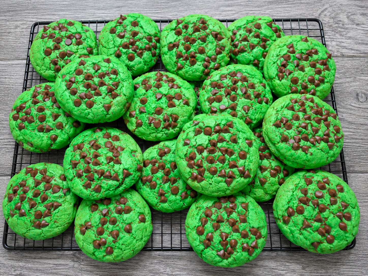 Green chocolate chip cookies with chocolate morsels, on a baking tray