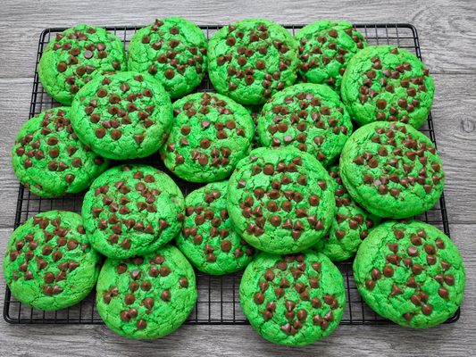 Green chocolate chip cookies with chocolate morsels, on a baking tray