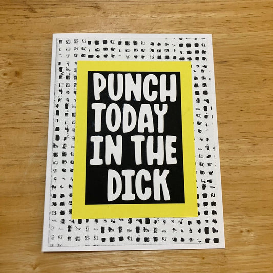 White text on a black background with a yellow border. Background paper is a gritty black and white gingham pattern. White card.