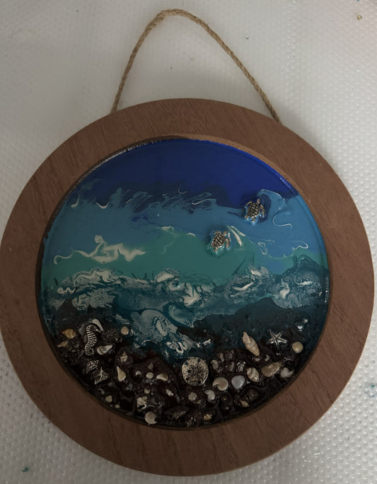 Ocean scene acrylic pour hanging circular frame.