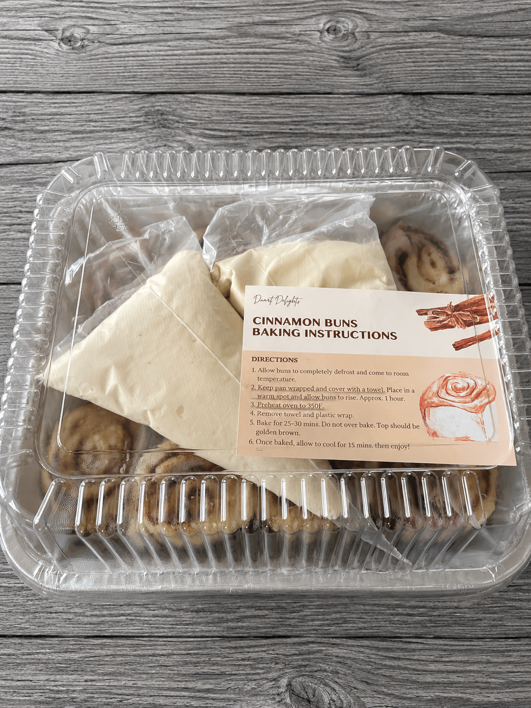 Cinnamon buns with baking instructions card in plastic tray and wrapping