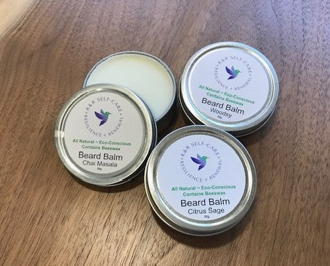 Beard balm tins set with three round metal containers; one open to show light balm