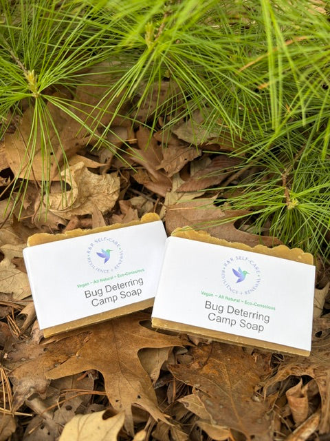 Bug-deterring camp soap bars with white labels, two bars