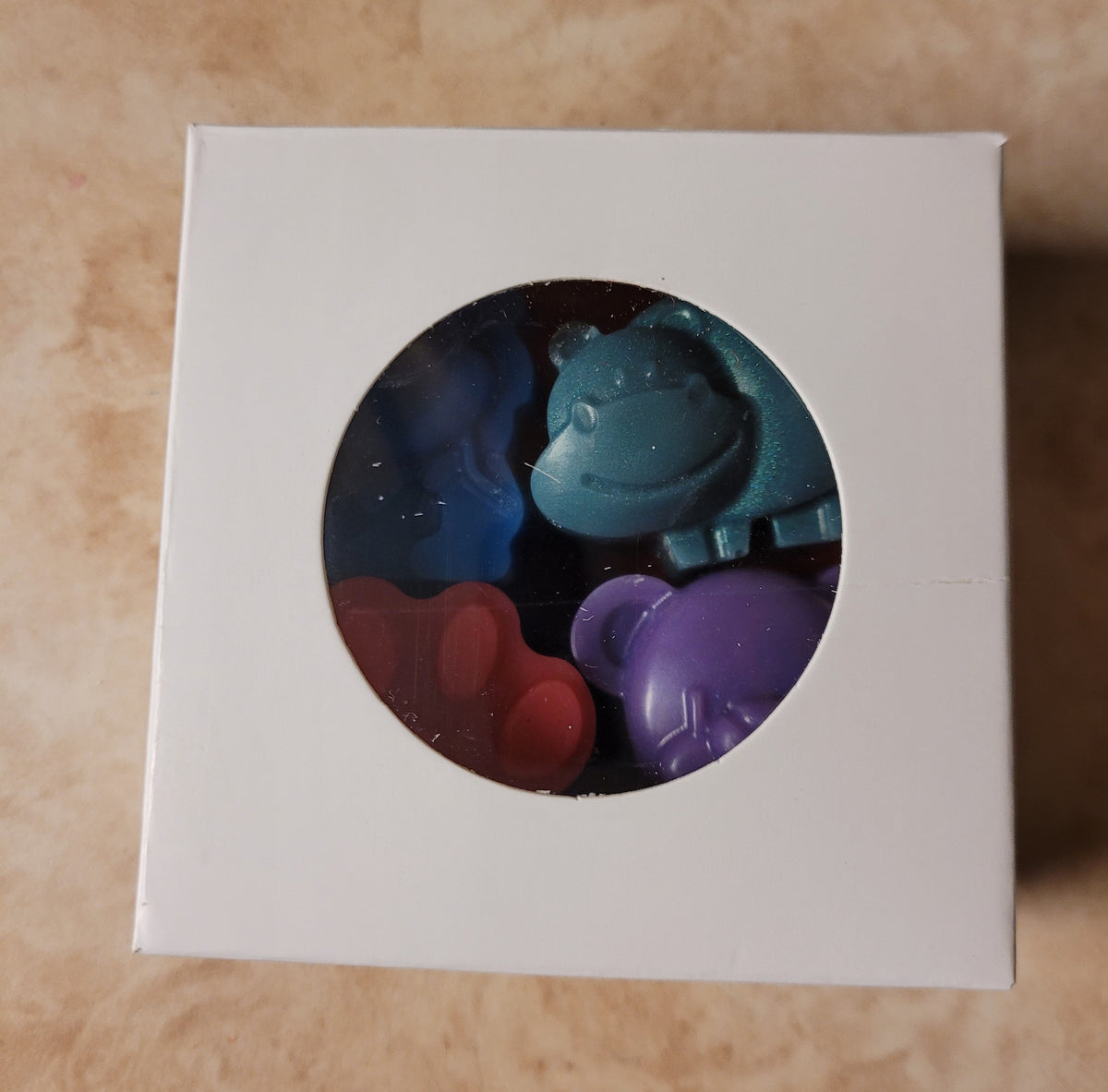 Bath crayon set in a box with blue, teal, red, and purple animal shapes visible