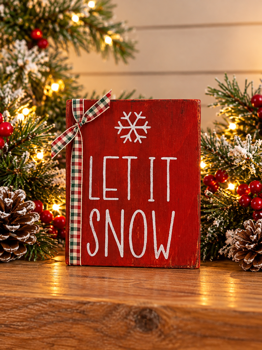 Red Let it Snow shelf sitter with plaid ribbon bow and white snowflake lettering
