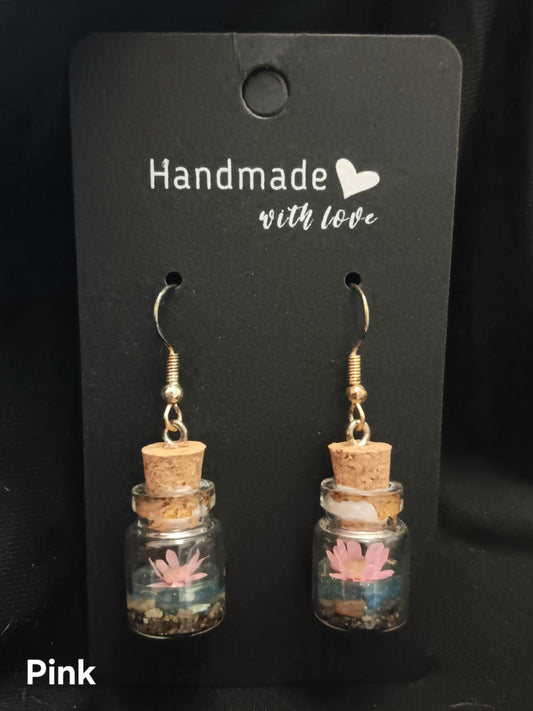 Pink flower in glass bottle dangle earrings with cork tops and gold hooks