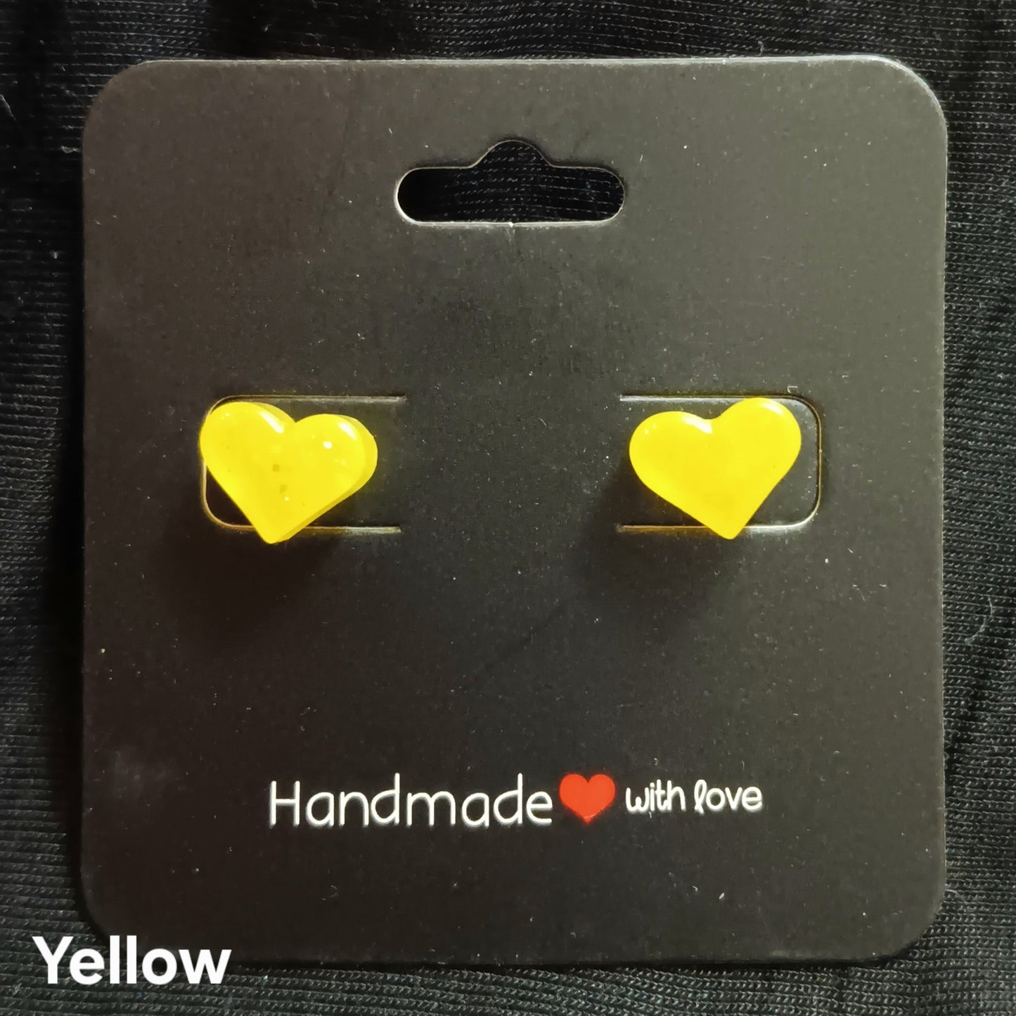 Yellow heart stud earrings with glittery heart stones on metal posts