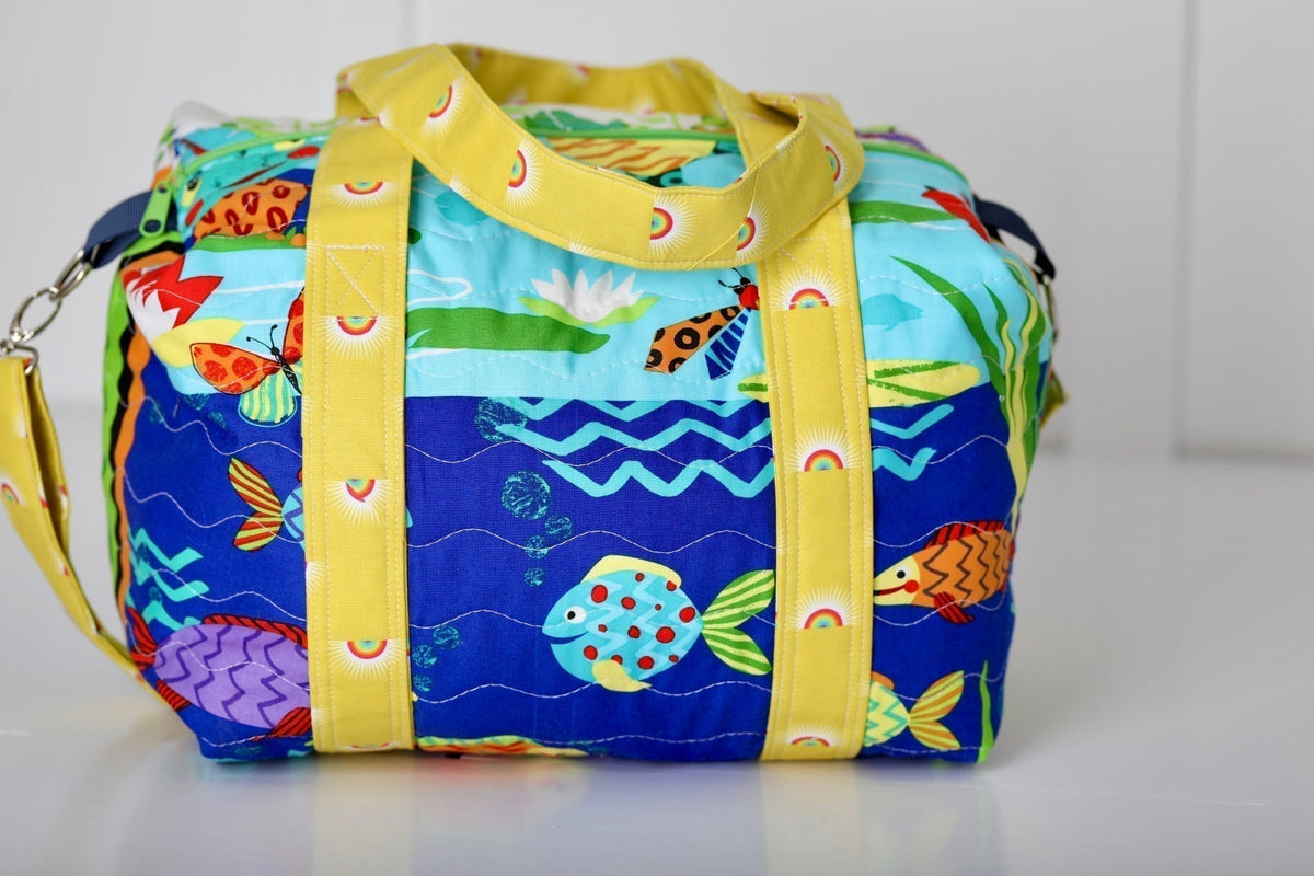 Kids duffle bag with colorful ocean animal print and yellow webbing straps, top zipper