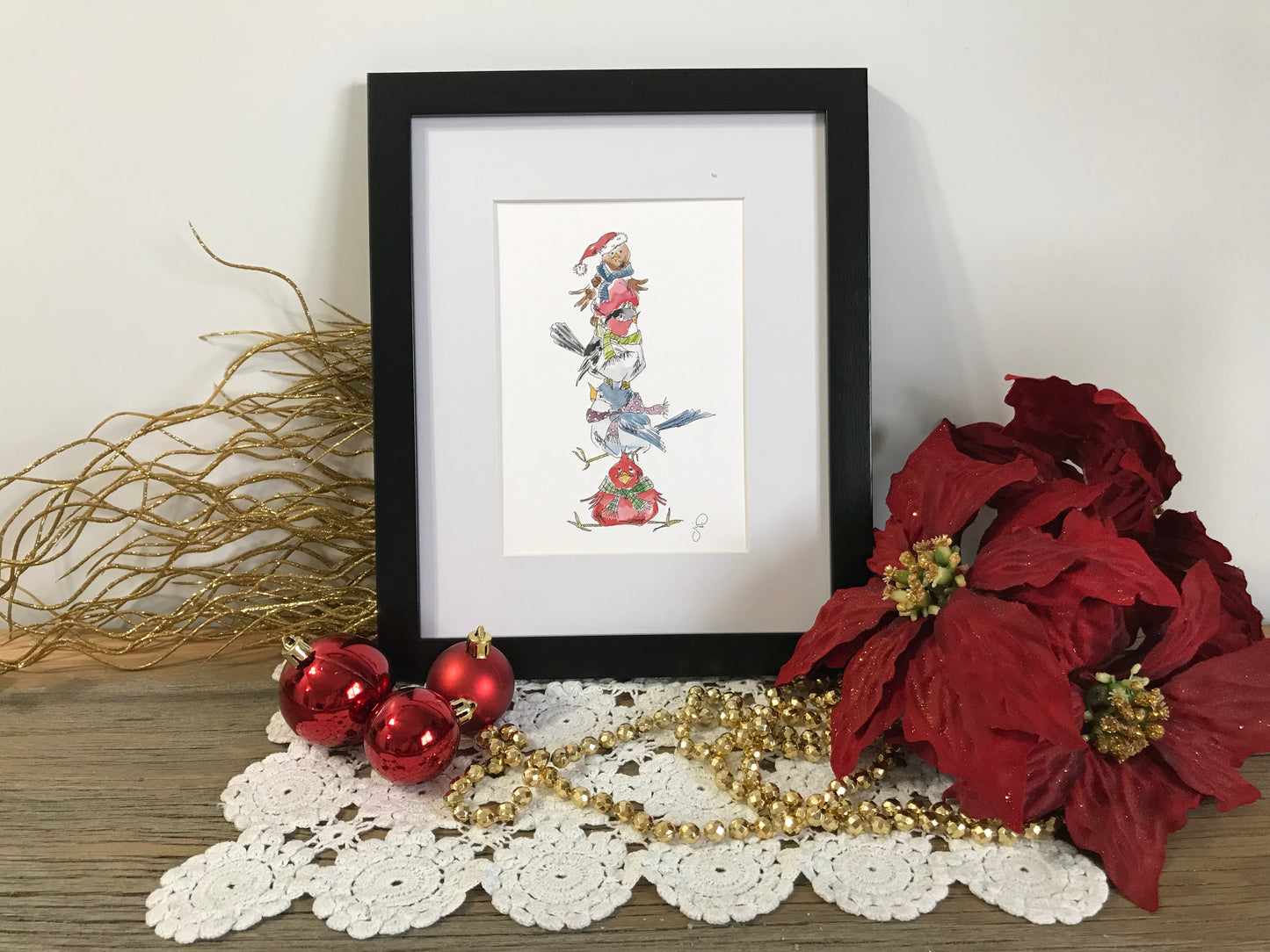 Framed stacked birds wall art with colorful bird illustration in black border