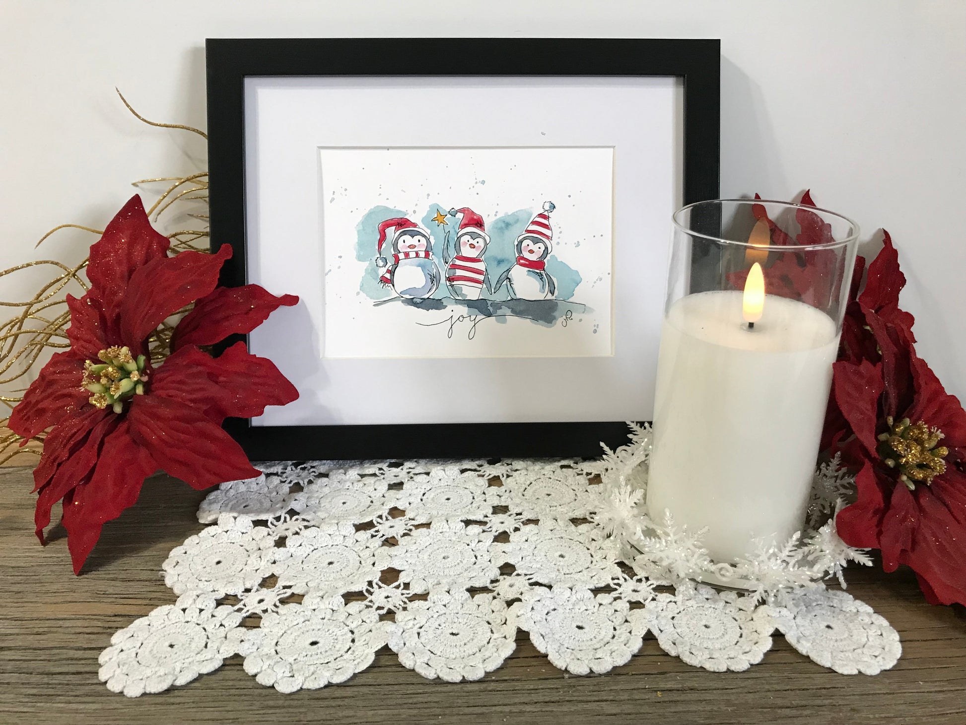 Framed penguin holiday artwork with two cartoon penguins and playful accents