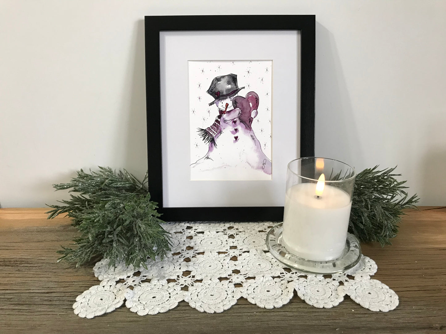 Framed snowman wall art print with purple scarf and black top hat, black border