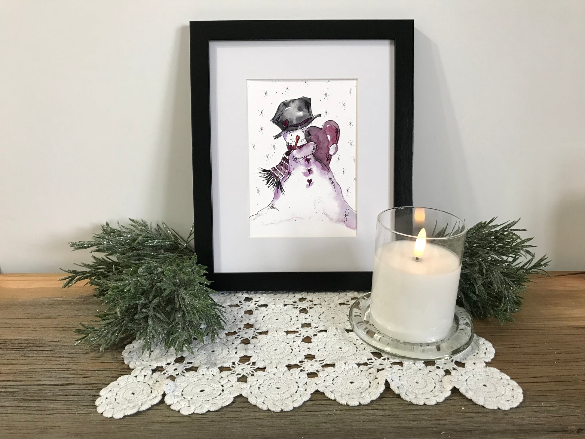 Framed snowman wall art print with purple scarf and black top hat, black border