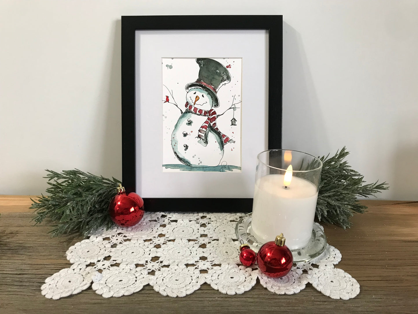 Framed snowman and cardinal wall art with birdhouse, black picture frame