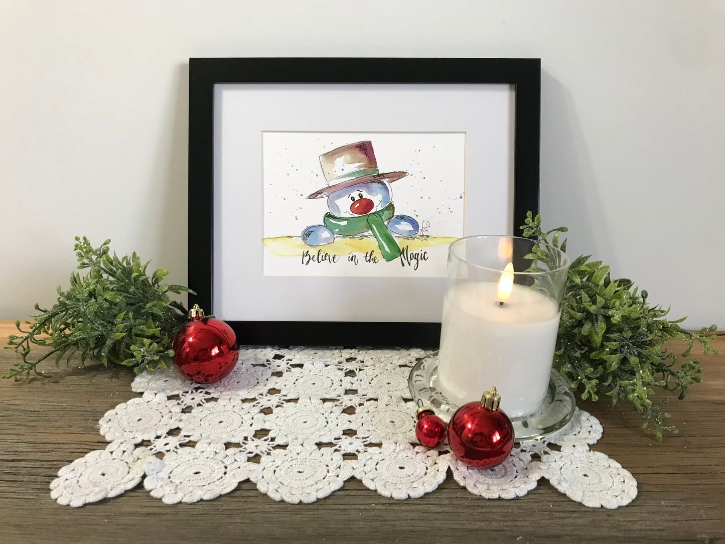 Framed snowman illustration wall art with magic text, light watercolor style