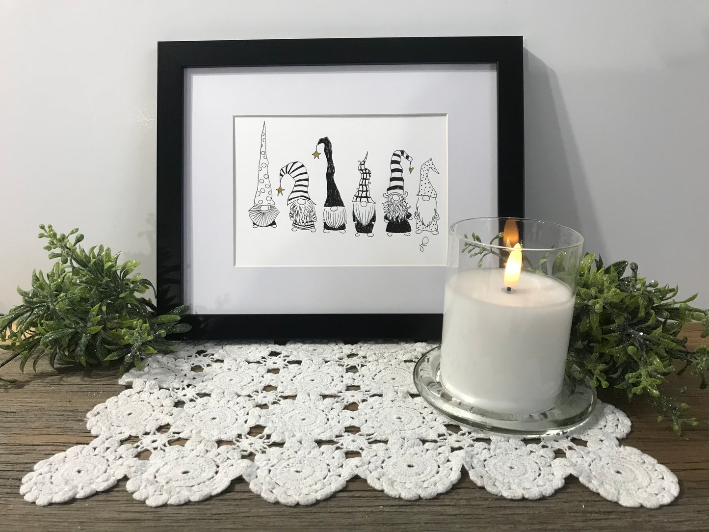 Framed gnome art print with four black-and-white playful gnomes