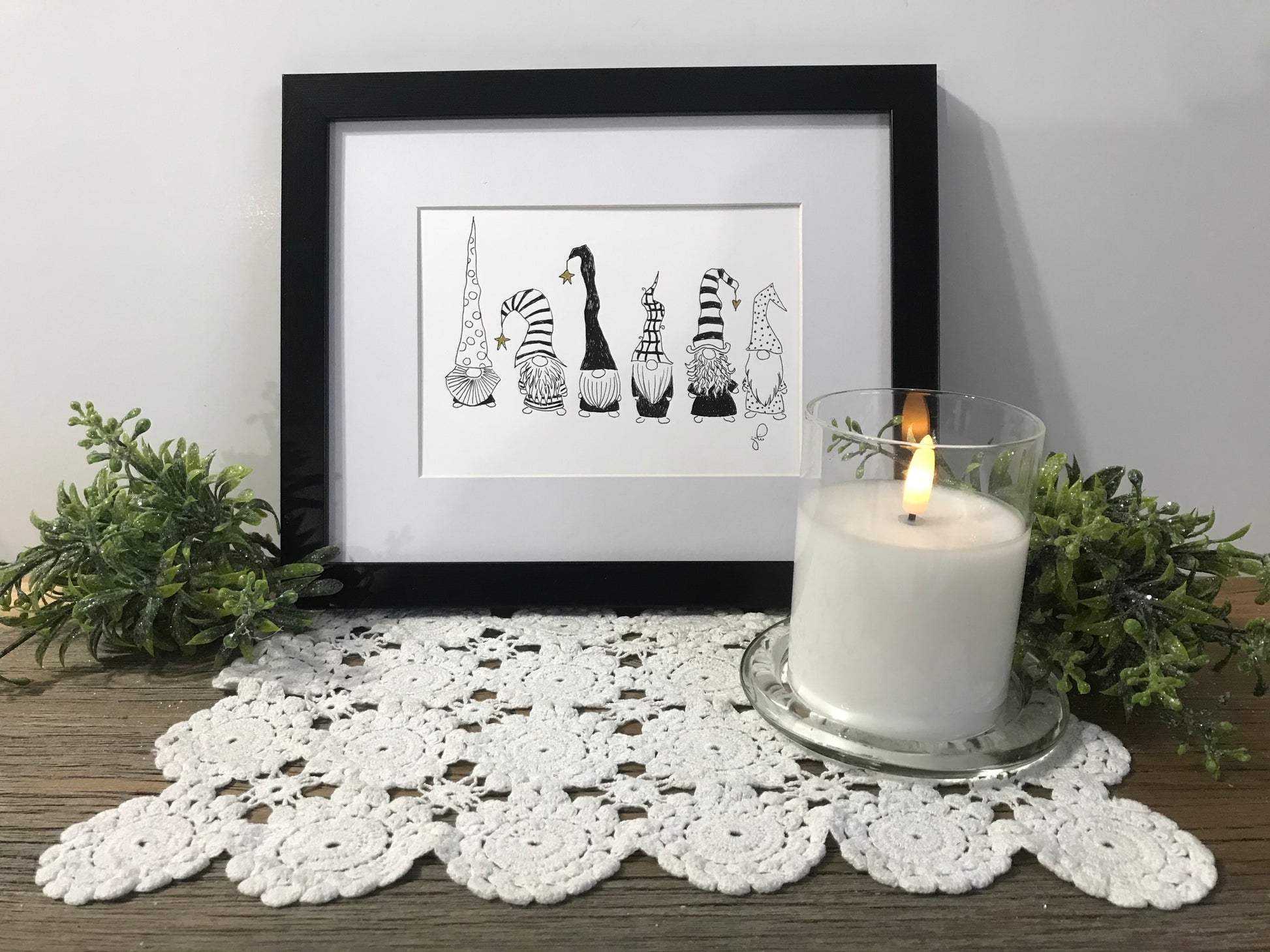 Framed gnome art print with four black-and-white playful gnomes