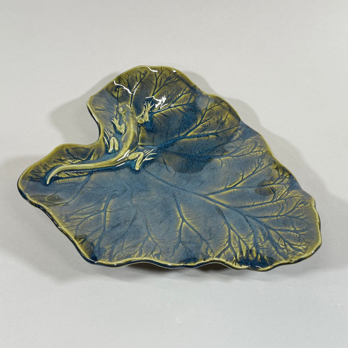 Rhubarb leaf-shaped serving platter, blue glaze with raised veins and gold rim