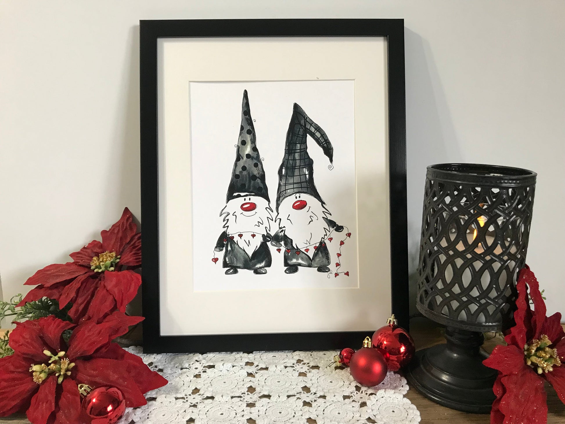Framed gnome couple wall art with two dark hats and red heart accents