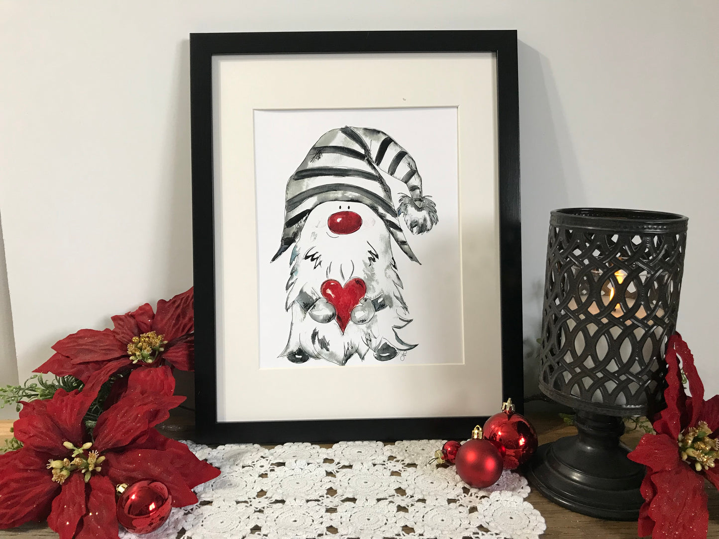 Framed gnome art print with striped hat and red heart detail on white background