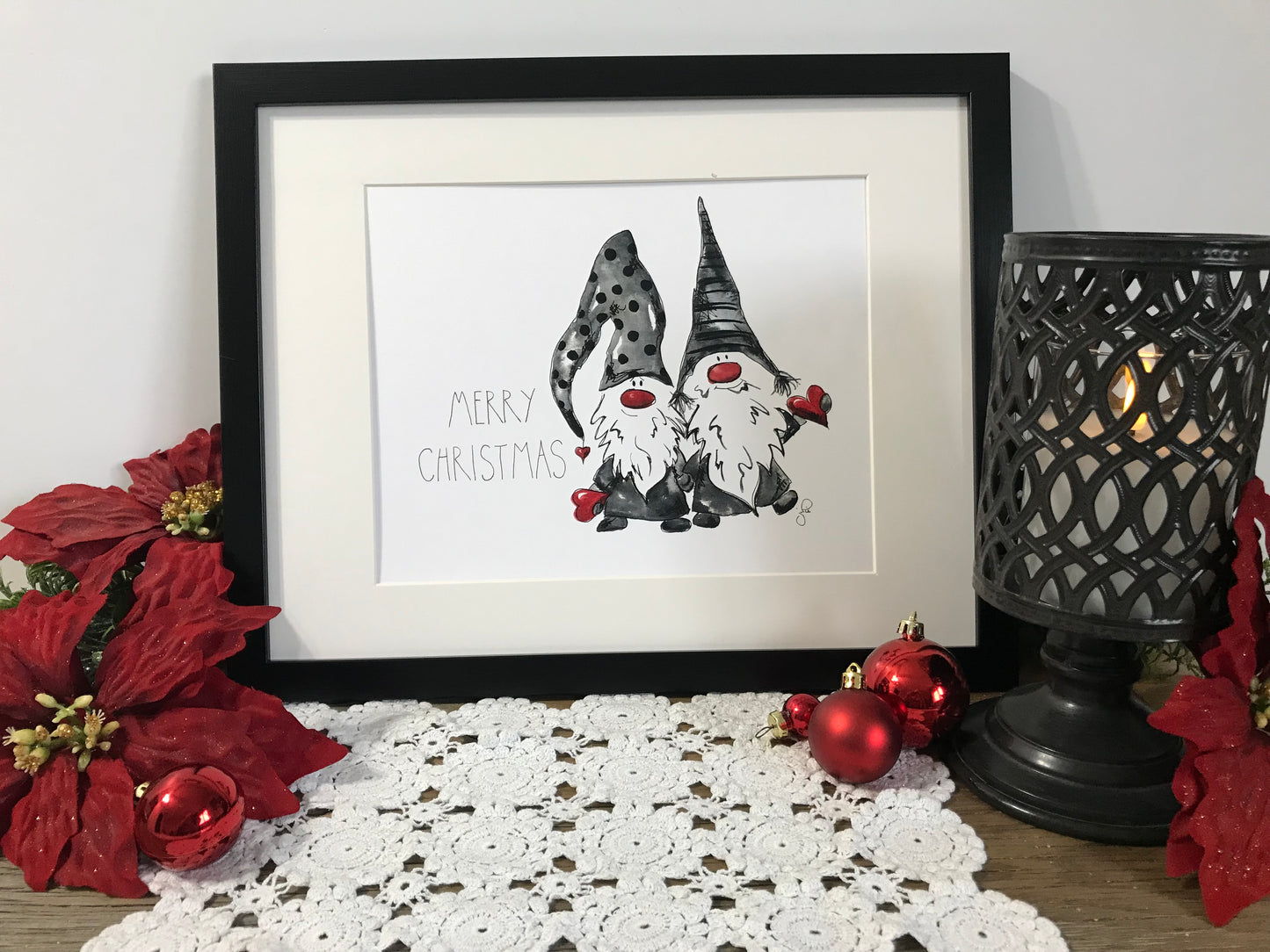 Framed watercolor-style gnome art with “Merry Christmas” text and three dark hats.