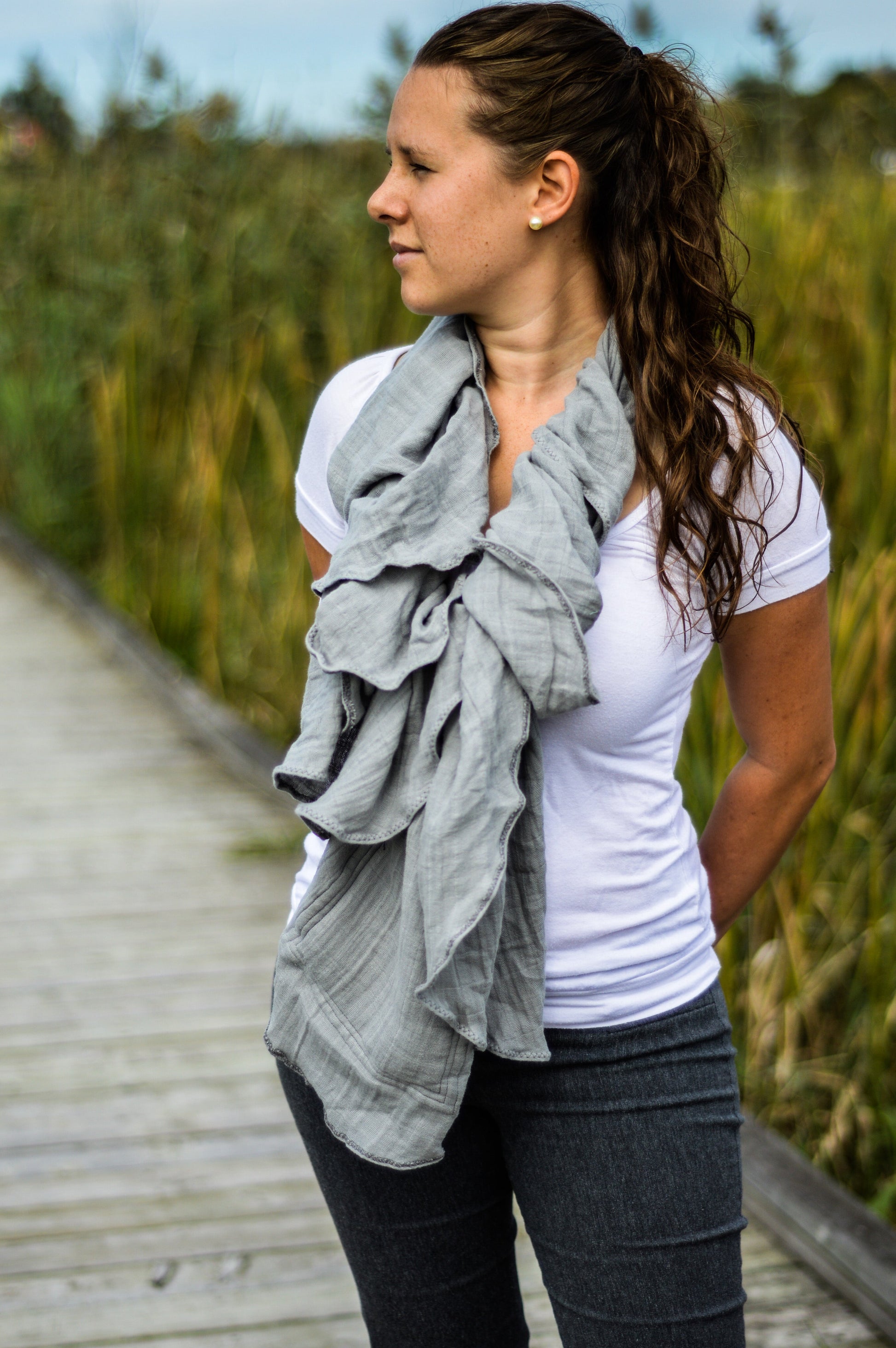 Grey breastfeeding cover with draped scarf style and black strap