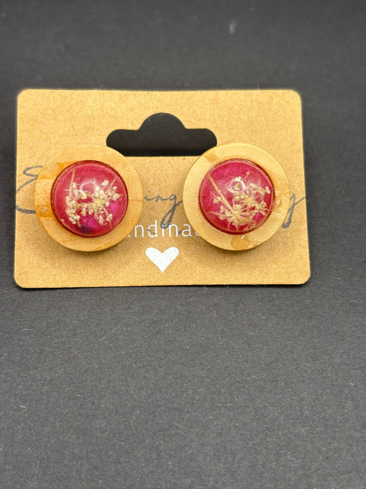 Round pink floral stud earrings with gold-toned center detail