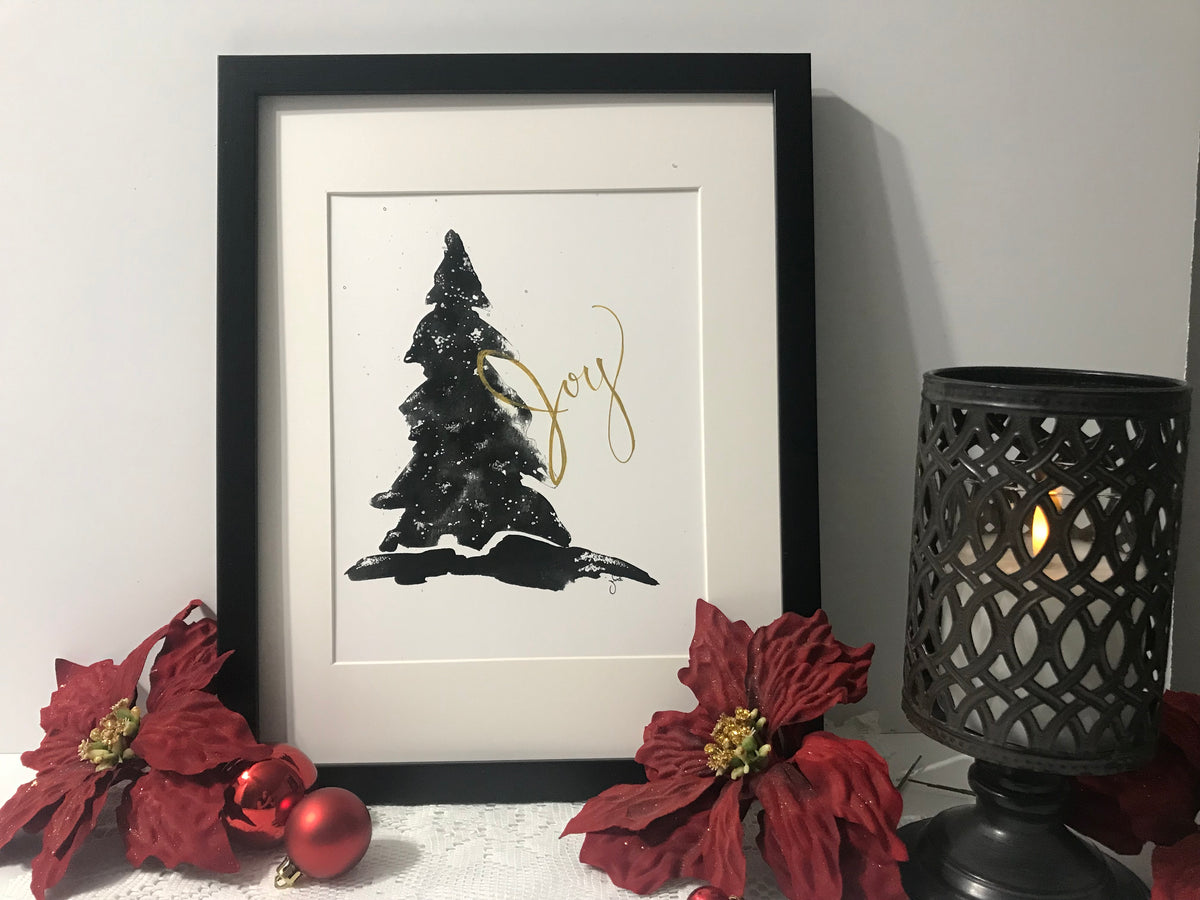 Framed wall art featuring a black Christmas tree with gold line ornaments
