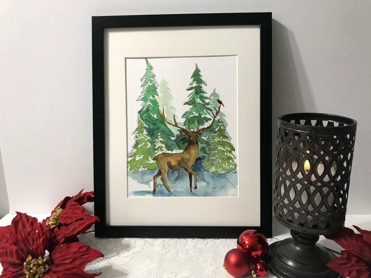 Framed reindeer and evergreen forest wall art print with standing deer and pines